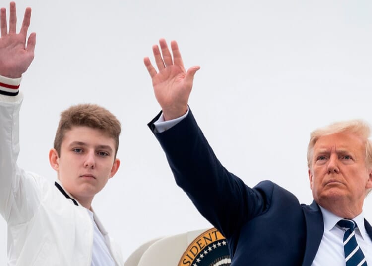 Then-President Donald Trump and his then-14-year-old son, Barron, wave as they board Air Force One at Morristown Municipal Airport in Morristown, New Jersey in an August 2020 file photo.