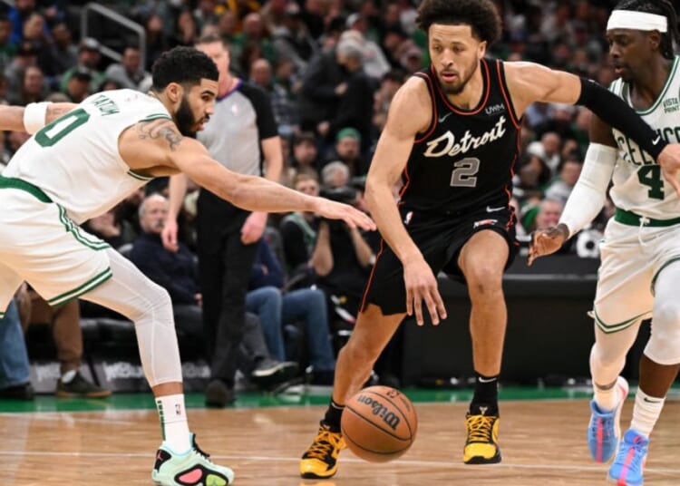 Cade Cunningham, #2 of the Detroit Pistons, drives to the basket against Jayson Tatum #0 and Jrue Holiday #4 of the Boston Celtics during the fourth quarter at Boston's TD Garden on Thursday.