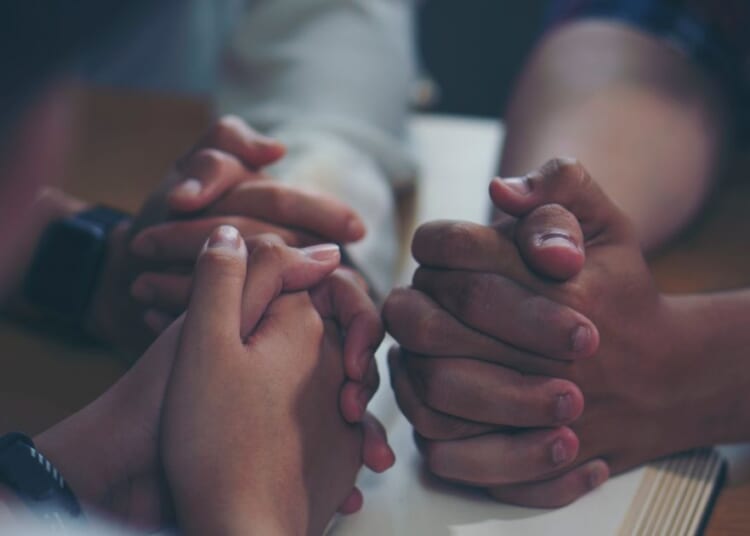 The above stock image is of people praying.