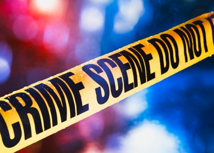 Stock image of police tape at a crime scene.