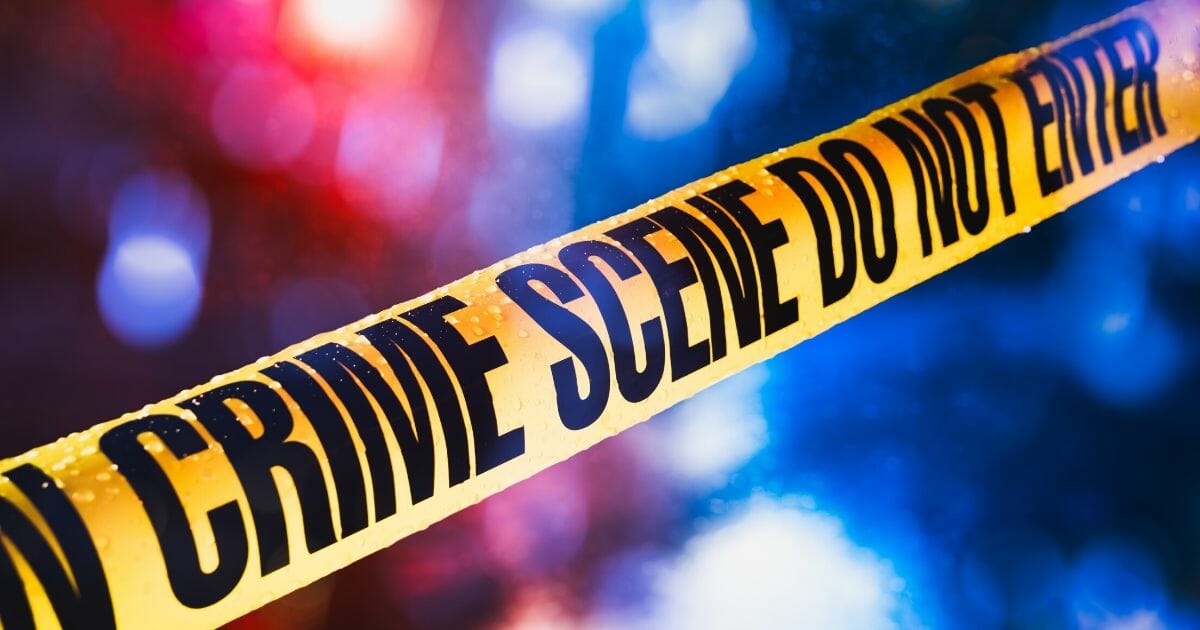 Stock image of police tape at a crime scene.